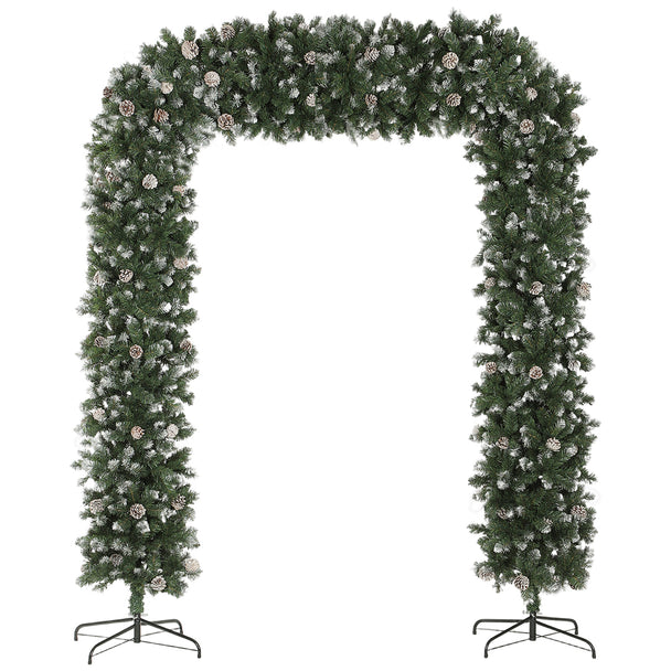 8.2ft snow-frosted Christmas tree arch with pine cones framing an indoor doorway