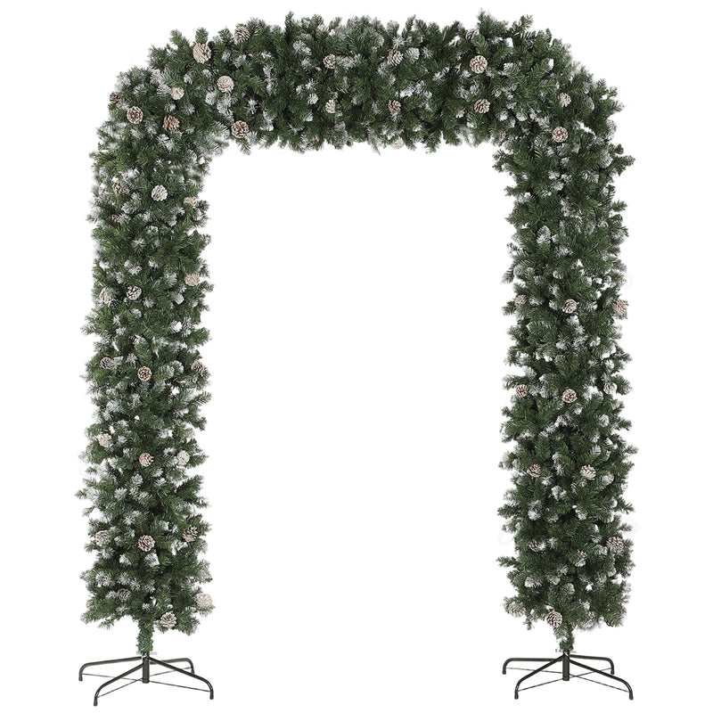8.2ft snow-frosted Christmas tree arch with pine cones framing an indoor doorway