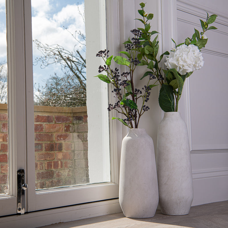 Darcy Ople vases with faux greenery by a window, shown with a larger vase sold separately