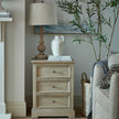 Delphine chest beside a sofa with a table lamp and ornament
