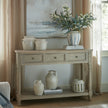 Delphine console styled with vases under artwork