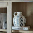 Ceramic jug on a shelf inside the dresser top