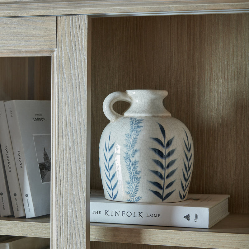 Ceramic jug on a shelf inside the dresser top