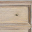 close-up of a panelled drawer front and brass-tone knob