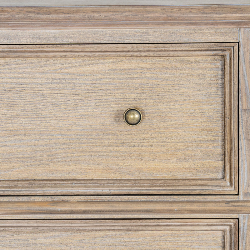 close-up of a panelled drawer front and brass-tone knob