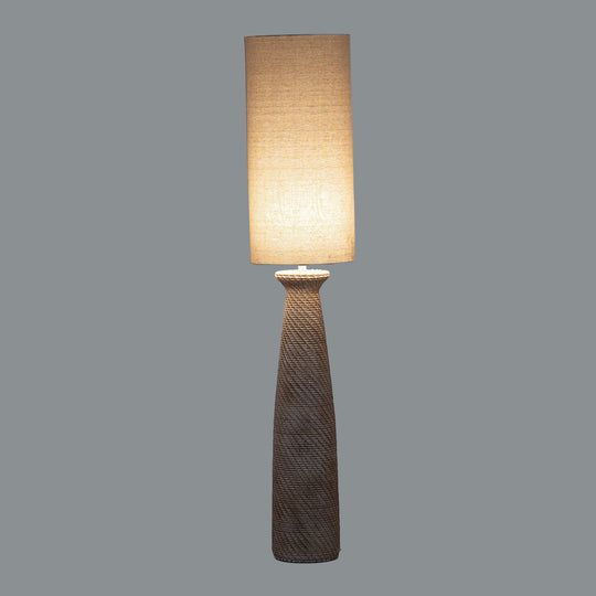 Dune floor lamp switched on against a grey background