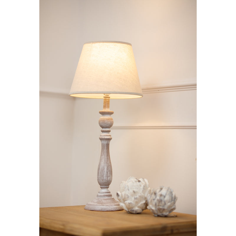 Dunum lamp lit on a wooden side table