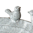Close-up of a speckled ceramic bird on the rim