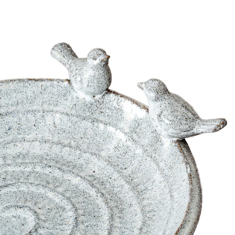 Close-up of the bird figures on the rim of the bath