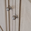 Close-up of the ribbed round metal door knobs