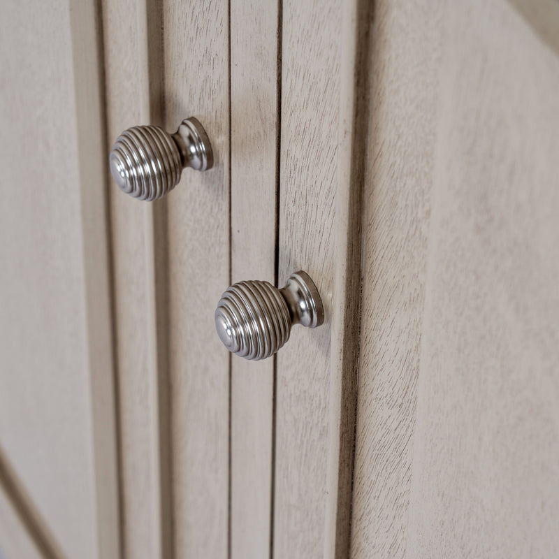 Close-up of the ribbed round metal door knobs