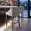Light grey bar stools along a kitchen island