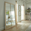 Washed wood window mirror in a bright living room