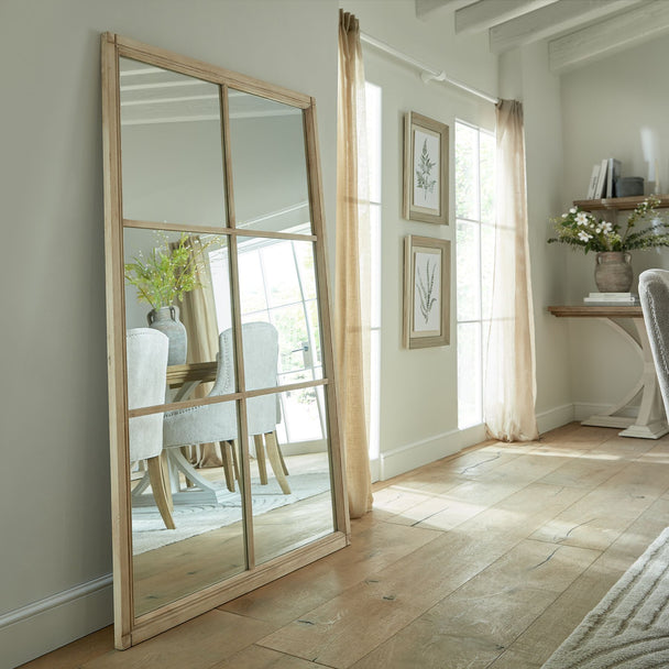 Washed wood window mirror in a bright living room