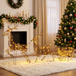 3-Piece Rattan Reindeer and Sleigh Christmas Light Set illuminated in a room