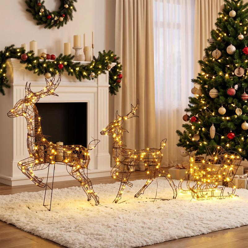 3-Piece Rattan Reindeer and Sleigh Christmas Light Set illuminated in a room