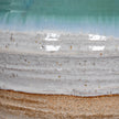 Close-up of the teal glaze, white band and terracotta base