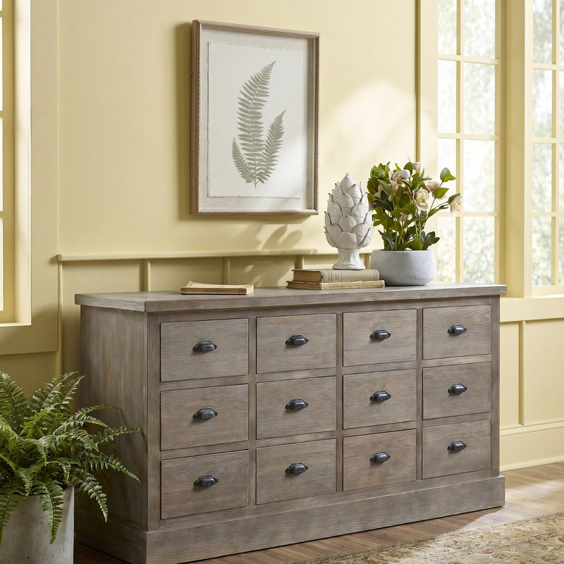 Fern framed art above a grey chest of drawers