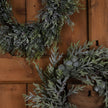 Frosted wreaths on a wooden door, close view