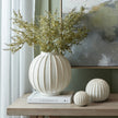 Grove globe vase with dried greenery on a console table