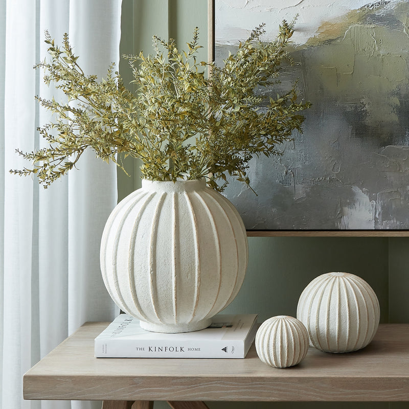 Grove globe vase with dried greenery on a console table