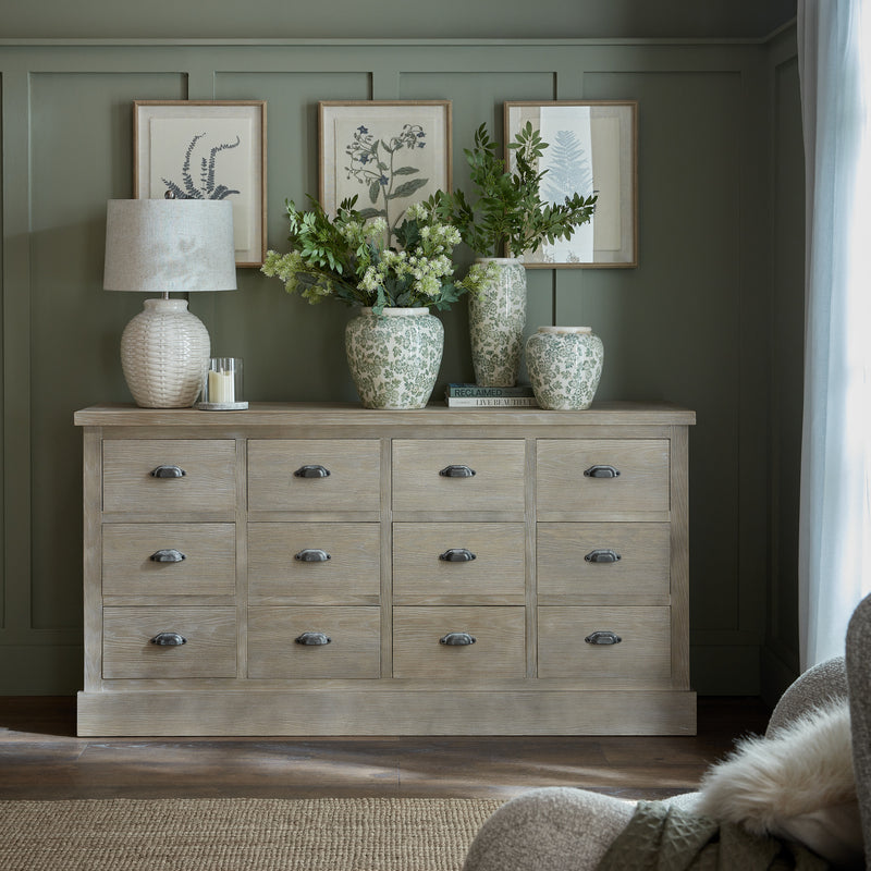 Haldon chest in a living room with table lamps, vases and botanical prints