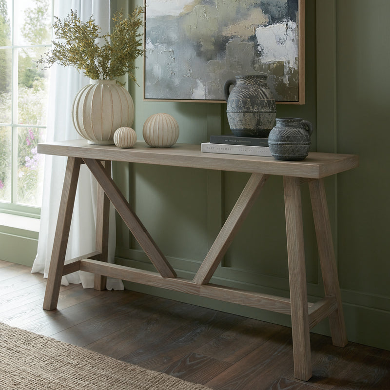 Haldon console styled with vases against a green wall
