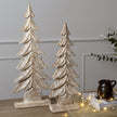 carved wooden trees with fairy lights on a table, shown with the smaller size sold separately