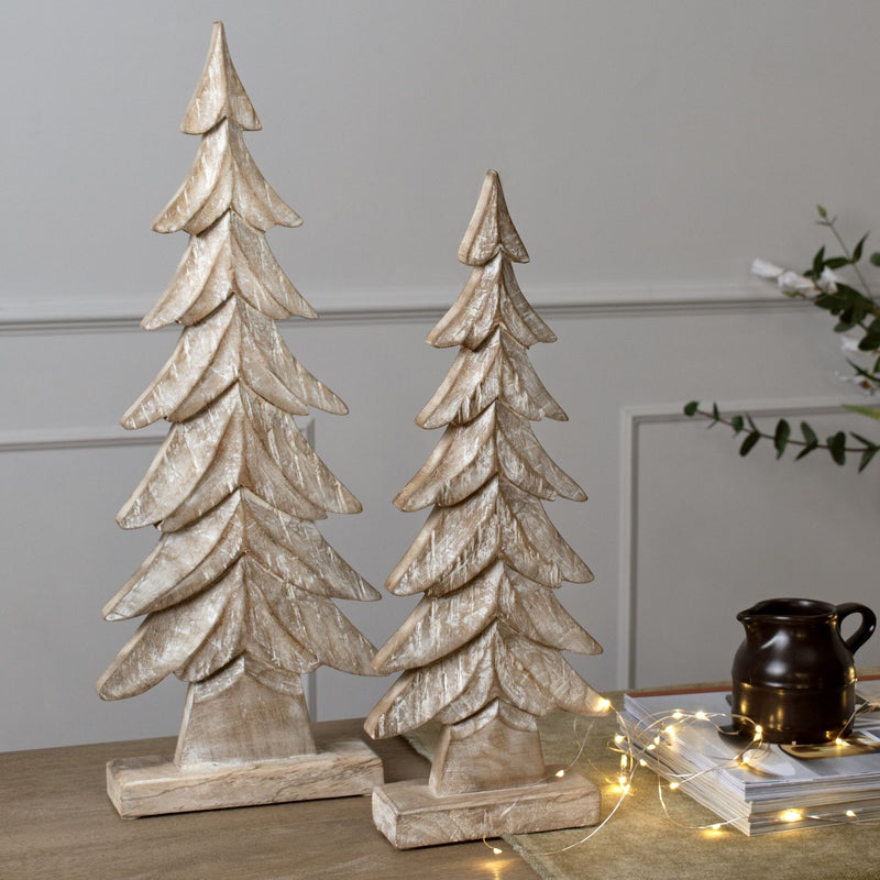 carved wooden trees with fairy lights on a table, shown with the smaller size sold separately