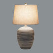 Harbour table lamp switched on against a grey background