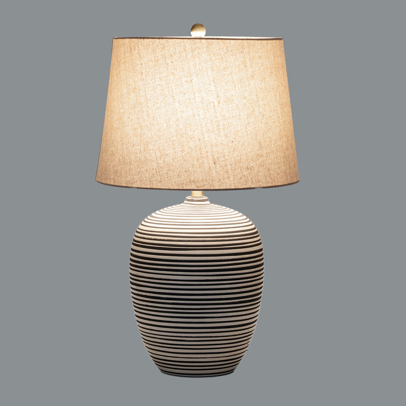 Harbour table lamp switched on against a grey background