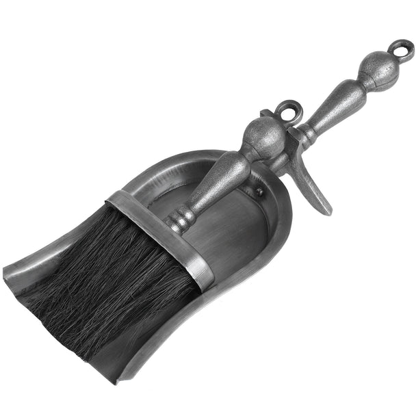 Antique pewter hearth tidy set with brush resting on the shovel