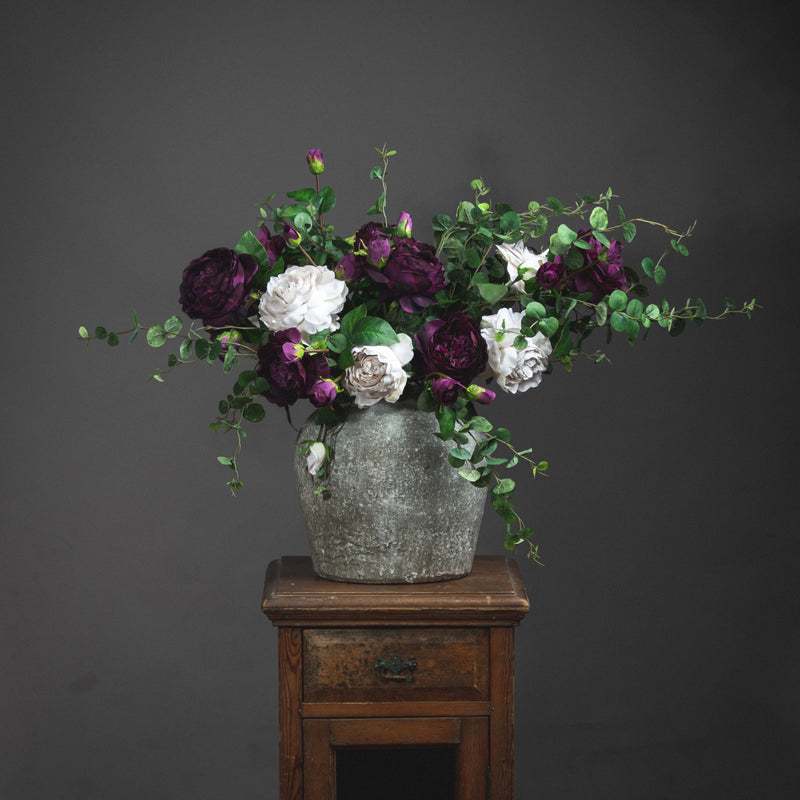 Aged Stone-Effect Ceramic Vase – 30cm, styled with flowers on a wooden stand