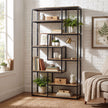 Industrial shelf unit styled with books and plants in a living room