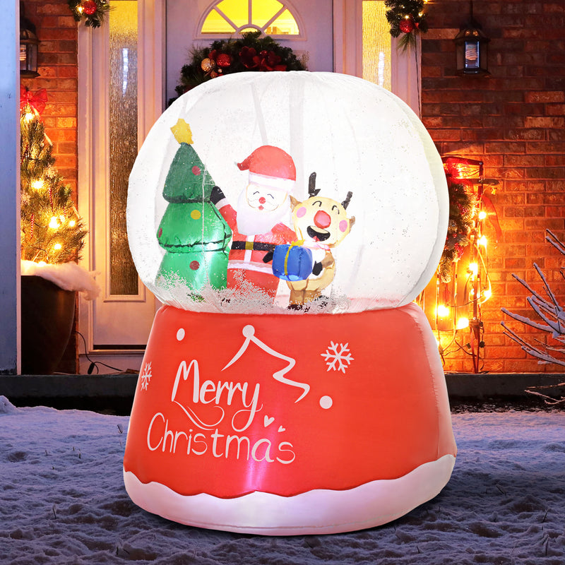 5.5ft Inflatable Christmas Snow Globe illuminated outside a home