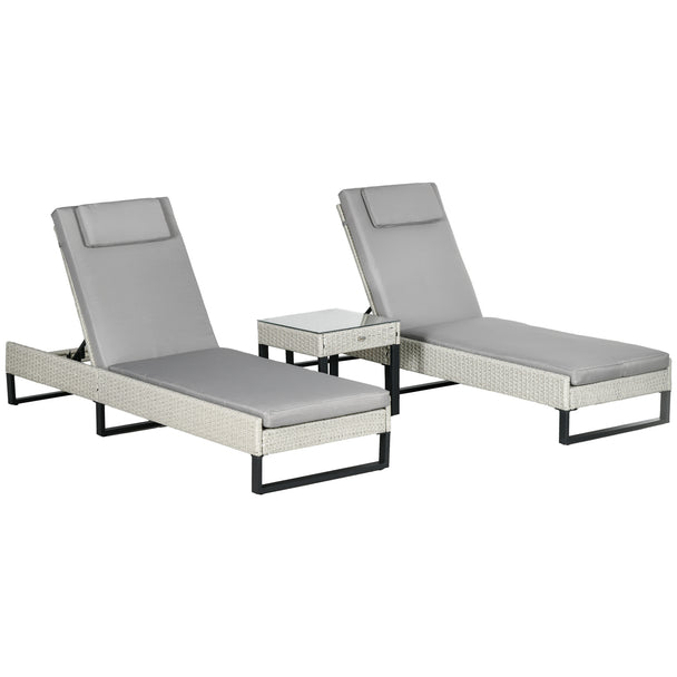 Two light grey rattan sun loungers with cushions and a glass-top side table