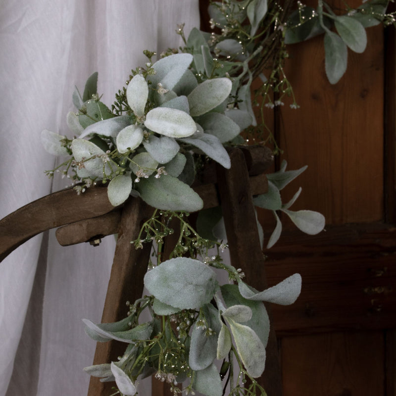 Lamb's ear garland draped over a wooden chair back