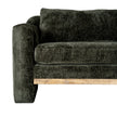 close-up of the textured green fabric, arm and wooden plinth