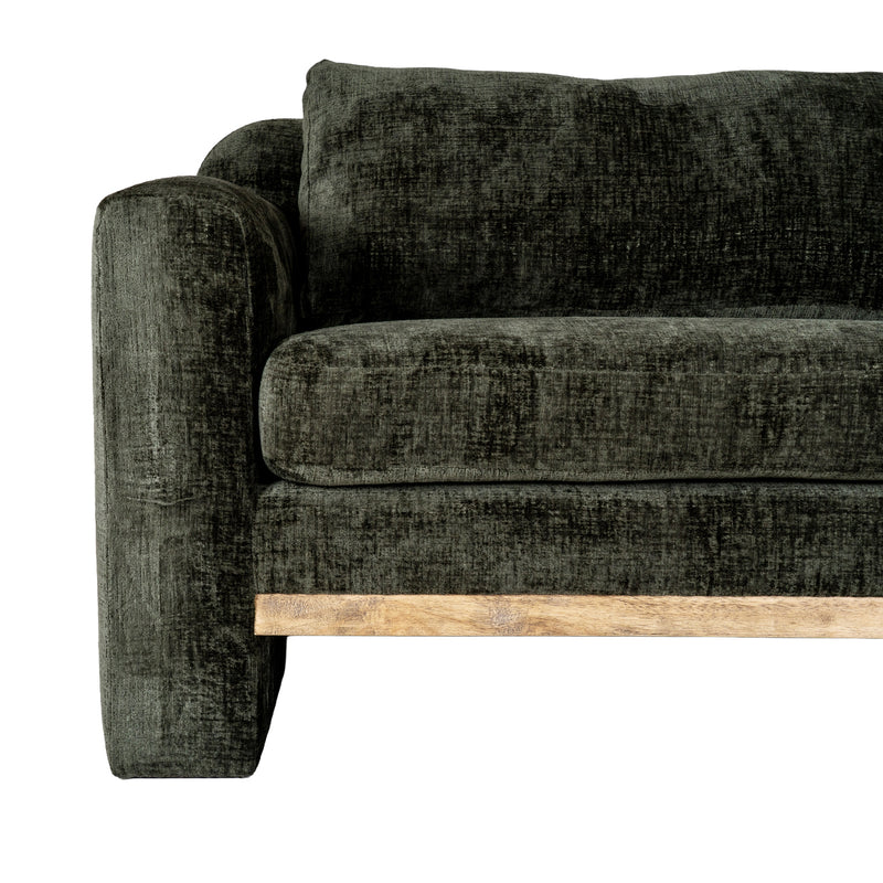 close-up of the textured green fabric, arm and wooden plinth