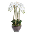 large white artificial orchid in a clear glass pot