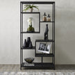 Black multi shelf unit styled with vases and frames
