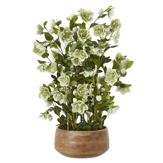 large green artificial hellebore in a taupe pot