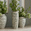 Green Clover vases with greenery on the floor, other vases sold separately