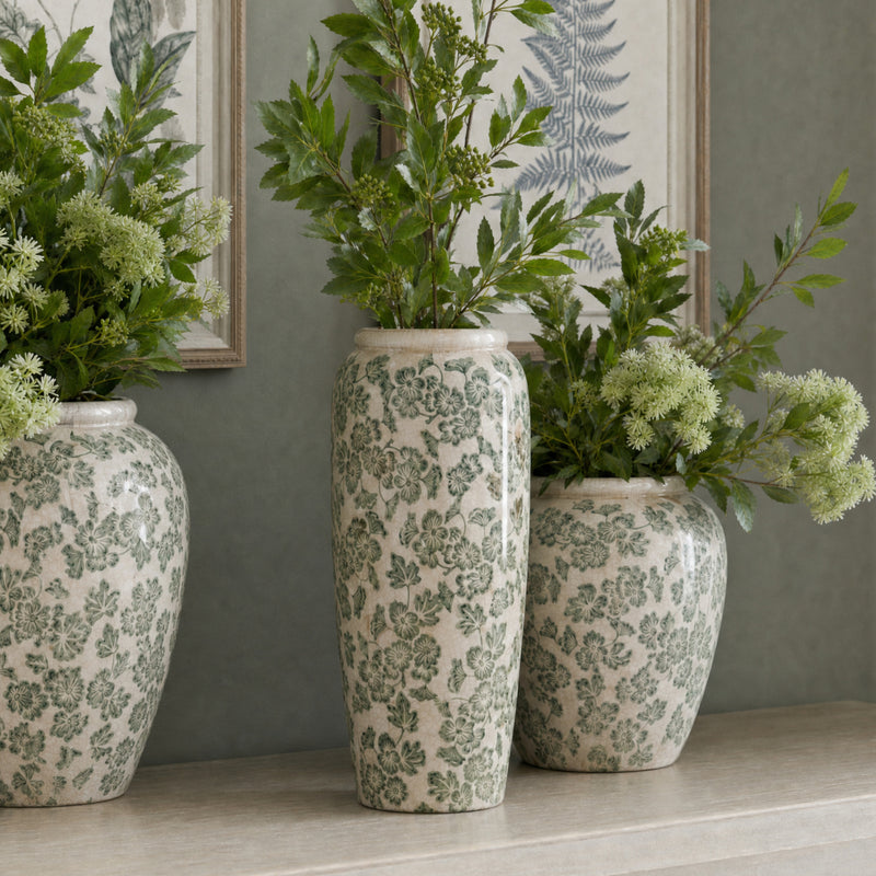 Green Clover vases with greenery on the floor, other vases sold separately