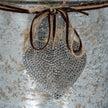 Close-up of the hammered-dot heart and twine bow