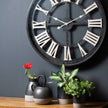Metallic grey planters with greenery on a shelf below a wall clock, other items sold separately