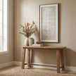 Plume feather art hung above a wooden console table