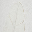 Close-up of the raised white quill on textured paper