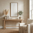 Quill feather art hung above a console table beside an armchair