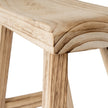 Close-up of the curved end of the wooden seat